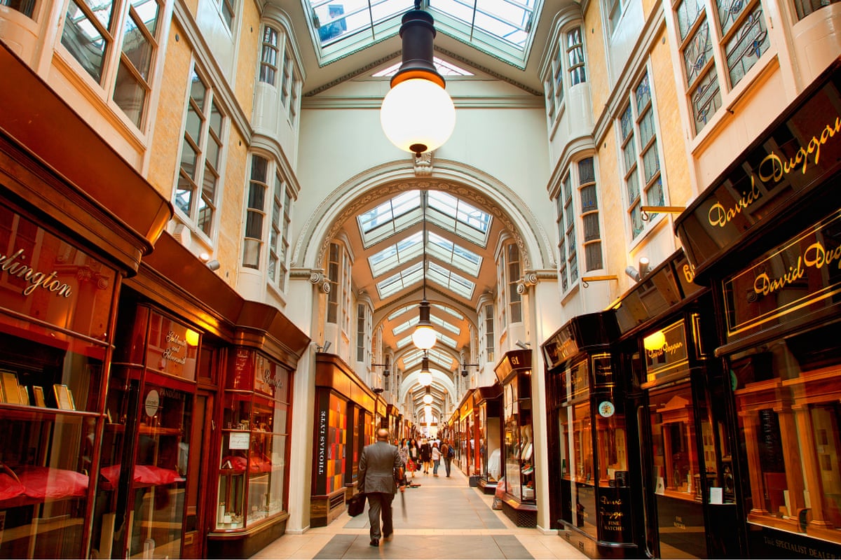 View down a very smart covered arcade of shops including jewellers.