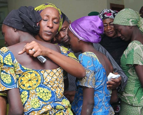 Oludolapo Osinbajo, the wife of the vice-president of Nigeria, hugs one of 21 Chibok girls released by Boko Haram.