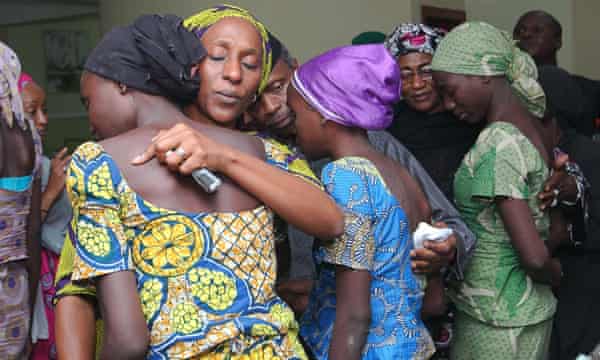 The wife of the vice-president of Nigeria, Dolapo Osinbajo, consoles one of the 21 released Chibok girls in October 2016.