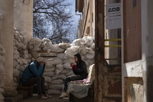 A volunteer smokes next to sandbags used for protection, at a Ukrainian volunteer centre in Mykolaiv, southern Ukraine.
