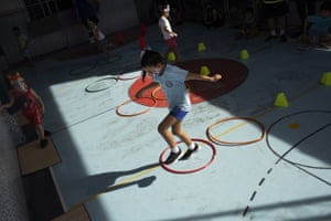 Rafaely de Melo jumps during gym class at the Pereira Agustinho daycare, nursery and pre-school, in Duque de Caxias, Brazil, after it reopened following the coronavirus lockdown