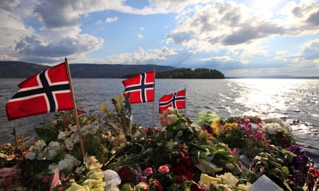 Norwegian flags and flowers are seen in Sundvollen, close to Utoya island, in the background, where a gunman killed 69 people in 2011.