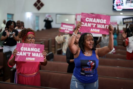 people hold signs that read ‘change can’t wait’