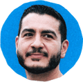 man looking to side with blue background