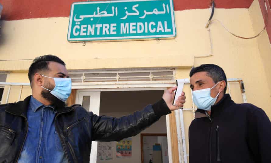 A man has his body temperature checked before receiving a vaccine dose in Algiers, Algeria on Monday.