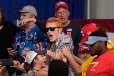A Trump supporter in a MAGA cap and a Gasdsen flag helped force an anti-ICE protester out of a Donald Trump rally in Dalton, Georgia on Friday.