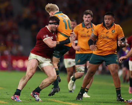 Tom Curry of the British & Irish Lions gives away a penalty for tackling Tom Lynagh of Australia in the air