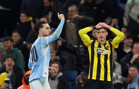 Manchester City's Rayan Cherki celebrates scoring as AEK Athens Stavros Pilios holds his head