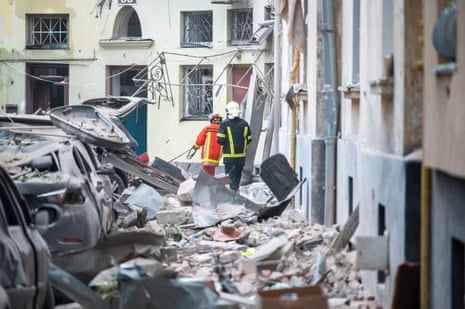 Rescue workers operate at a four-storey residential building that was struck by a missile attack on Lviv.