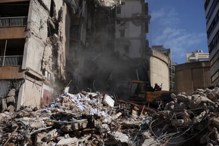 Rescuers using an excavator to search for people under the rubble, at the site of an Israeli strike on Wednesday in Beirut.
