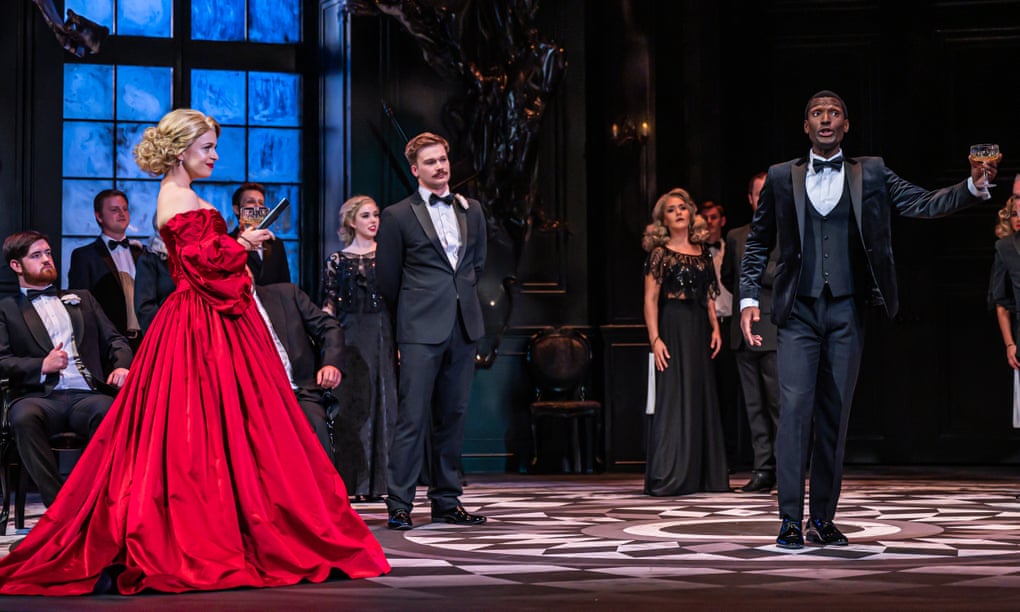 Siobhan Stagg, left, as Violetta, with Noah Stewart, right, as Alfredo, and company, in La Traviata.