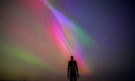 Aurora borealis over the installation Another Place by Anthony Gormley, Crosby Beach, Liverpool