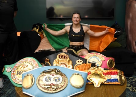 Katie Taylor celebrates with her title belts in her dressing room after Friday’s win.