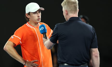 Alex de Minaur of Australia is interviewed after his opponent, Milos Raonic of Canada, retired injured from their round one singles match at the 2024 Australian Open.