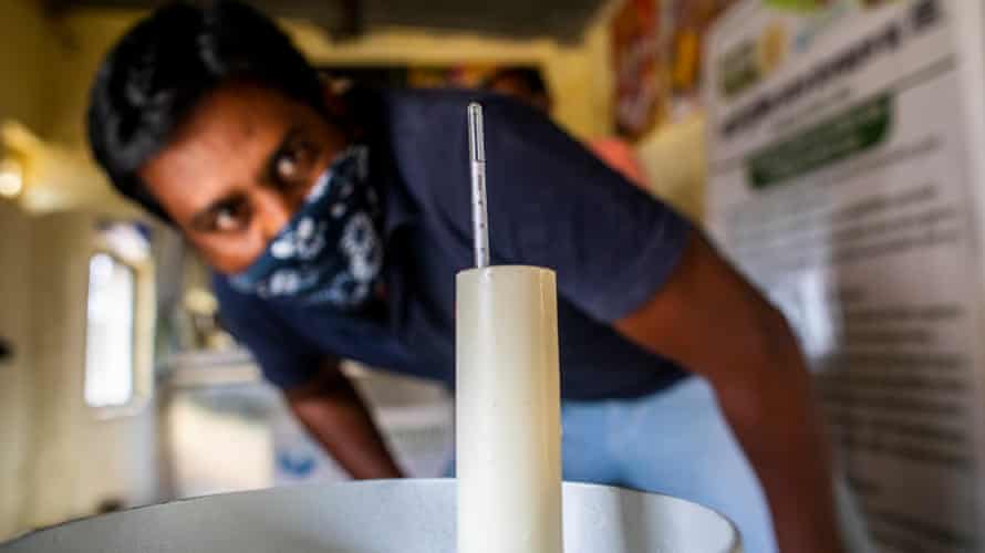 Testing the quality of the milk at Lakshmi Dairy in Karajgaon