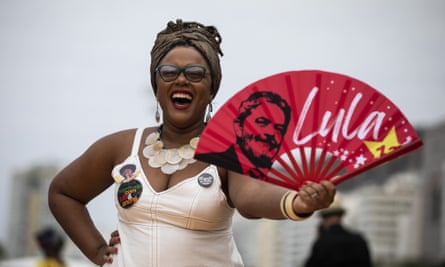 A woman holds a fan with the image of ‘Lula’ da Silva during a Black Women’s March in Rio de Janeiro, 31 July.