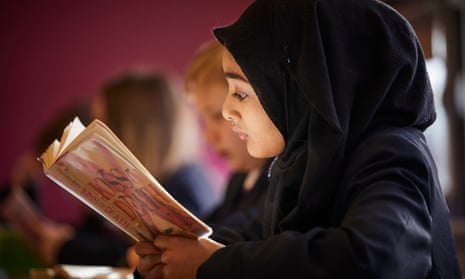Schoolgirl in headscarf reading book