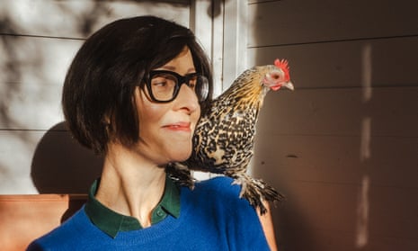 Emma Beddington at home with a chicken on her shoulder.
