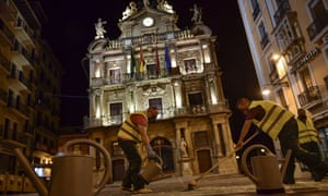 Workers of the City Hall impregnate the route of the running of the bulls with an anti-slip product