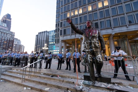 Pennsylvania police behind a defaced statue of Frank Rizzo.