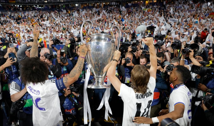 Marcelo and Luka Modric show off the trophy to the Real Madrid fans.