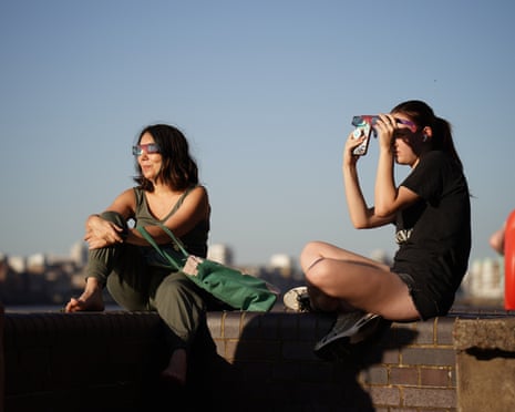 People watching the solar eclipse at King's Stairs Gardens in Bermondsey, south London, the first total solar eclipse visible over mainland Europe since 1999.
