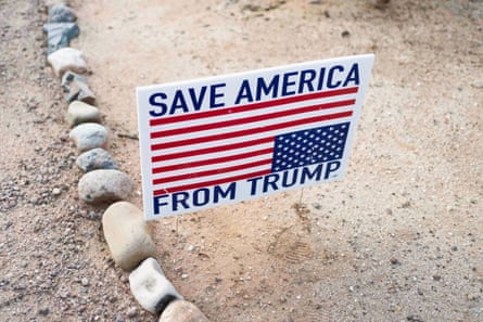 A sign reads “Save America from Trump”