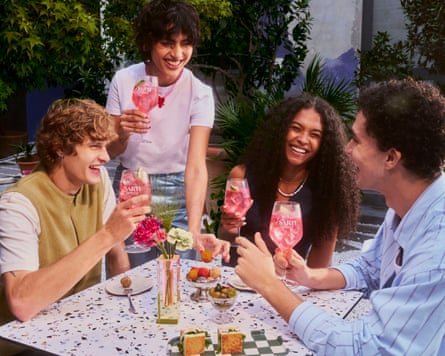 Four young people drinking pink Sarti spritzes