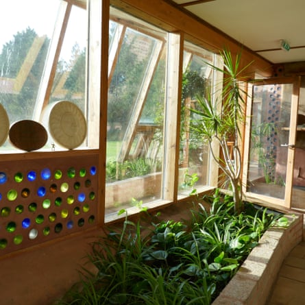 Interior showing plants and artwork at Earthship Brighton, UK.