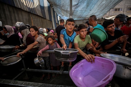 Palestinians children at food aid organization in Nuseirat refugee camp in Gaza City on Saturday.