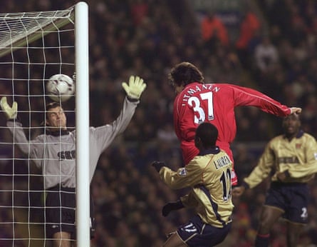 Jari Litmanen rises above Lauren to pull a goal back and give Liverpool hope in the second half.
