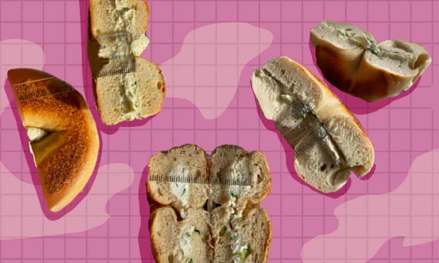 A variety of bagels with cream cheese.