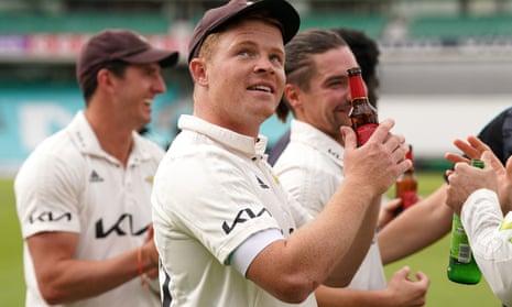 Ollie Pope enjoys a well-earned beer after helping Surrey to the Division One title. 