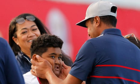 Tony Finau celebrates with family on the 15th green after winning the match.