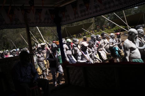 In a tribal customary ritual to honour the dead, Ganiga tribesmen and women, painted in clay, perform funeral chants at the haus krai at the ceremonial grounds on Kilima plantation