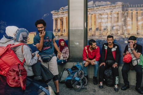 Somar and the rest of the group in front of a mural of the Acropolis.