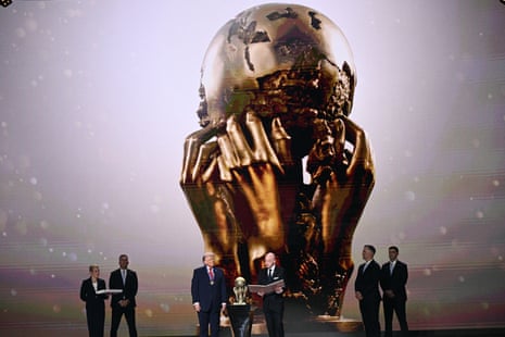 President Donald Trump looks on as he receives the FIFA Peace Prize from Gianni Infantino during the draw for the 2026 World Cup at the Kennedy Center, in Washington DC