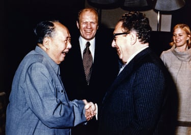 Chairman Mao Zedong shaking hands with Henry Kissinger as President Gerald Ford and his wife look on