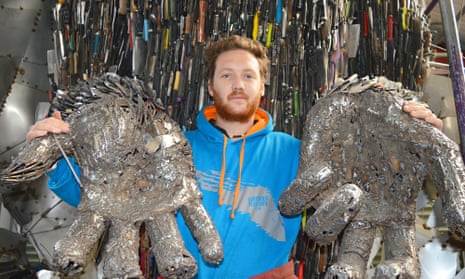 Sculptor Alfie Bradley with artwork made from weapons collected after police knife amnesties