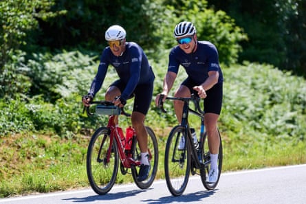 Miguel Induráin and Sir Chris Hoy riding side by side on bikes.