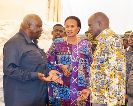 Three Ugandan politicians talking in a cluster