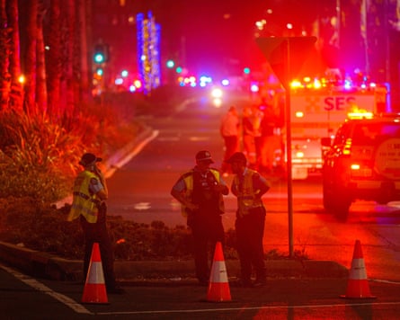 Police officers stand near a cordoned area of Bondi beach