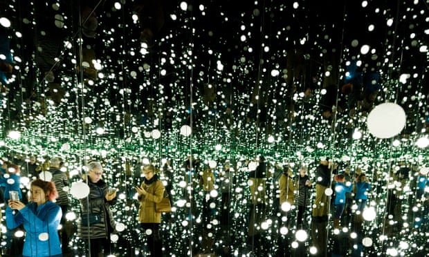 Visitors in Yayoi Kusama’s Infinity Mirrored Room: Dancing Lights That Flew Up to the Universe, 2019 at the David Zwirner Gallery in New York.
