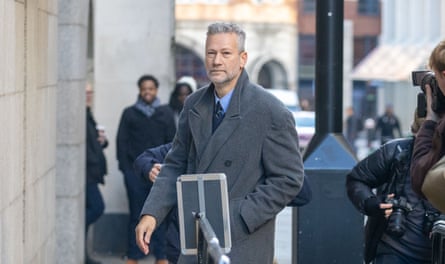 Man walks past photographers.