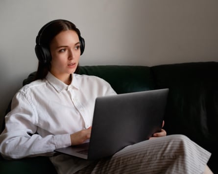 Portrait of young woman working on laptop computer indoors