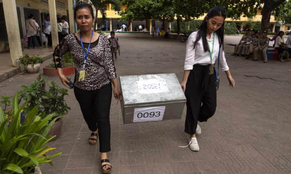 Women carry a ballot box in Phnom Penh, Cambodia