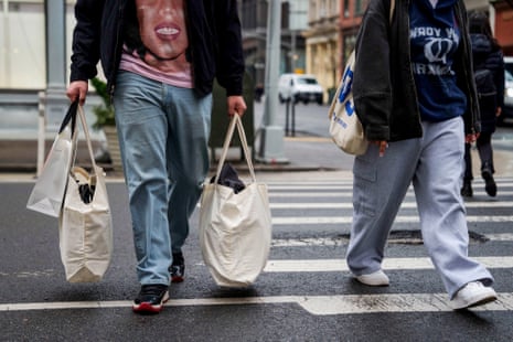 Shoppers carry bags as they worry about not being able to afford shit soon