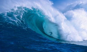 Surfer shooting the curl of Jaws at Peahi on Maui