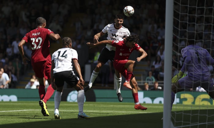 Fulham's Aleksandar Mitrovic, top right, scores during the English Premier League soccer match between Fulham and Liverpool at Craven Cottage