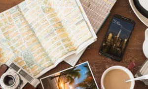 array of a travel related items grouped on a table including a smartphone